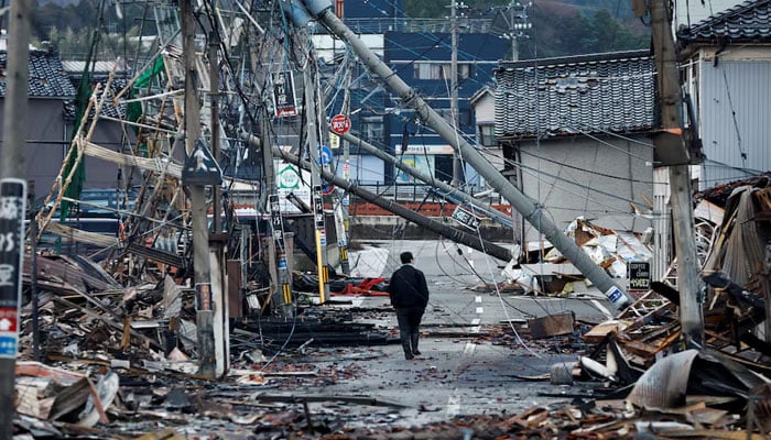 A man makes his way along Asaichi-dori street, which burned down due to a fire following an earthquake, in Wajima, Japan, January 4, 2024. — Reuters