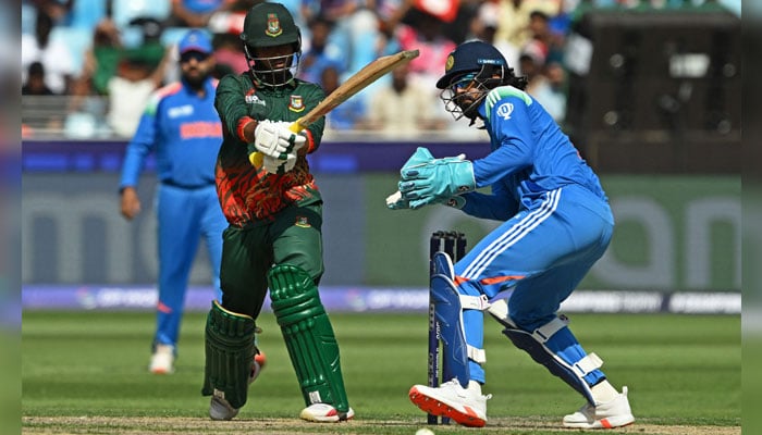 (From left) Bangladeshs Towhid Hridoy plays a shot as Indias wicketkeeper KL Rahul watches during the ICC Champions Trophy one-day international (ODI) cricket match between Bangladesh and India at the Dubai International Stadium in Dubai on February 20, 2025. — AFP