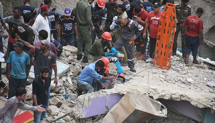 Rescue workers search for victims under the rubble after the five-story residential building collapsed in Karachi on July 4, 2025. — Online