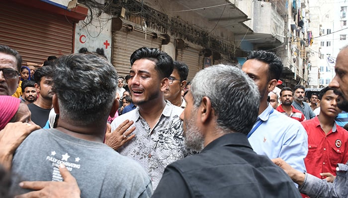 A man cries after a building collapse in Karachis Lyari kills several, on July 4, 2025. — Online