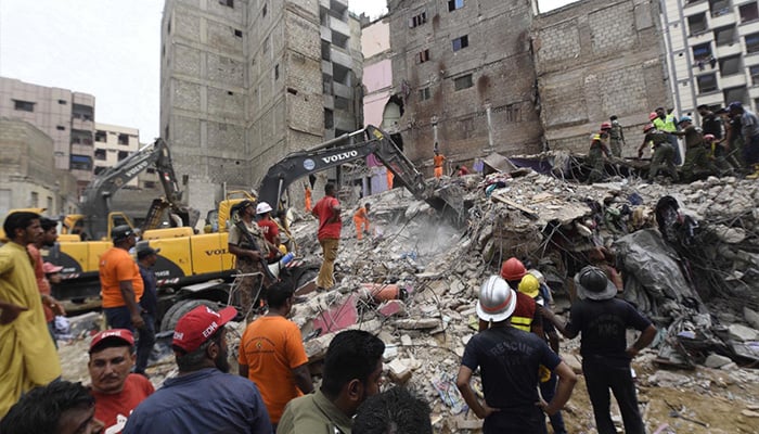 Rescue workers searching bodies from rubble after a five-storey building collapsed in Baghdadi, Lyari. — INP/File