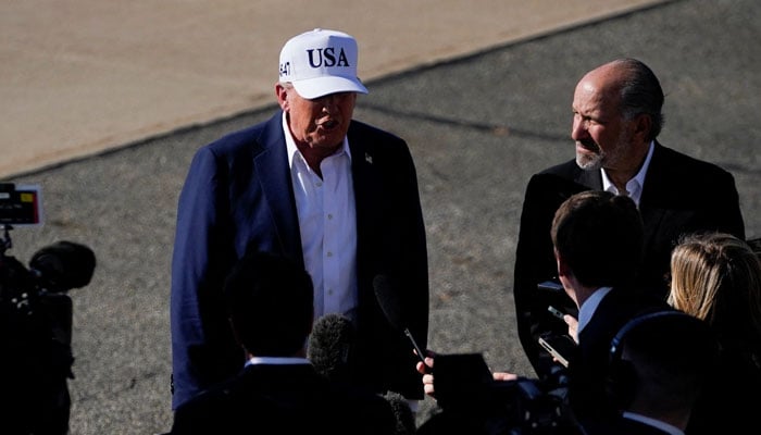 US President Donald Trump stands next to US Secretary of Commerce Howard Lutnick, as he speaks to members of the media, upon his arrival at Morristown Airport, in Morristown, New Jersey, US, July 6, 2025. — Reuters