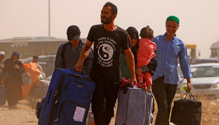 Afghan refugees arrive from Iran at Islam Qala border between Afghanistan and Iran, on July 5, 2025. — AFP