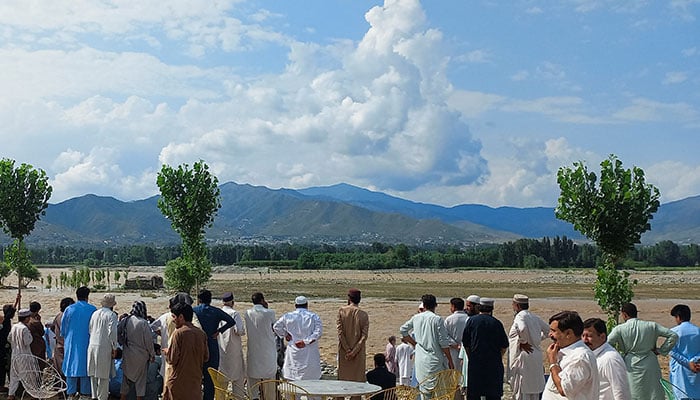 Residents gather, after tourists, who were on a picnic, were swept away by overflowing floodwaters in the Swat River, in Swat Valley on June 27, 2025. — Reuters