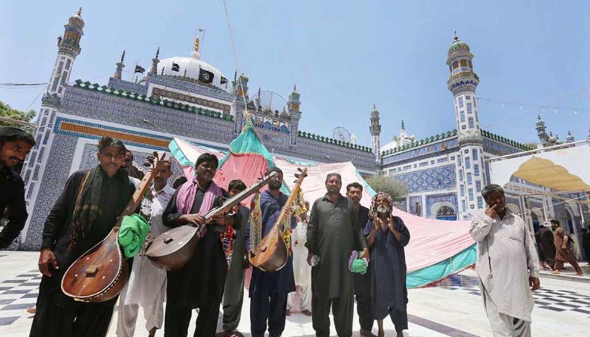 Folk musicians at the shrine of Shah Abdul Latif Bhitai on the occasion of 280th Urs celebration. — APP/File
