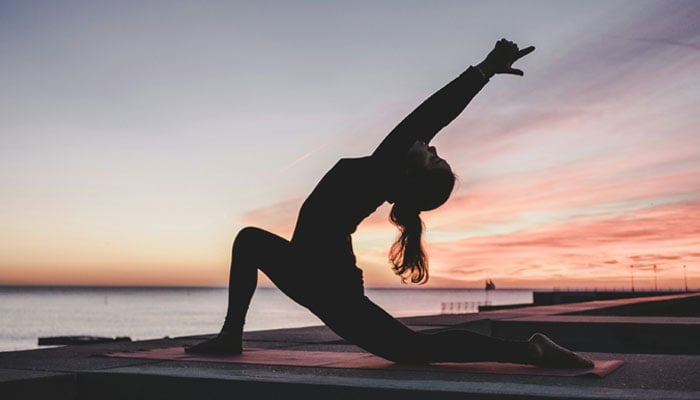 This representational image shows a woman doing yoga. — Unsplash
