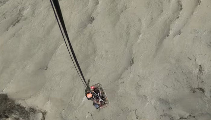 A member of the Nepalese army airlifts people stranded during the flood at Bhotekoshi river, Nepal, July 8, 2025. — Reuters