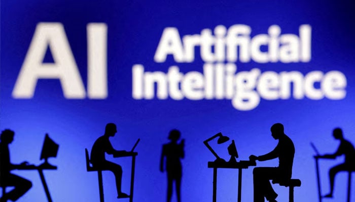 Figurines with computers and smartphones are seen in front of the words Artificial Intelligence AI in this illustration taken on February 19, 2024. — Reuters