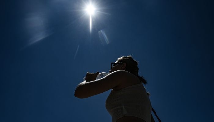 A tourist drinks water during a heatwave in Thessaloniki, Greece, on July 8, 2025. — AFP