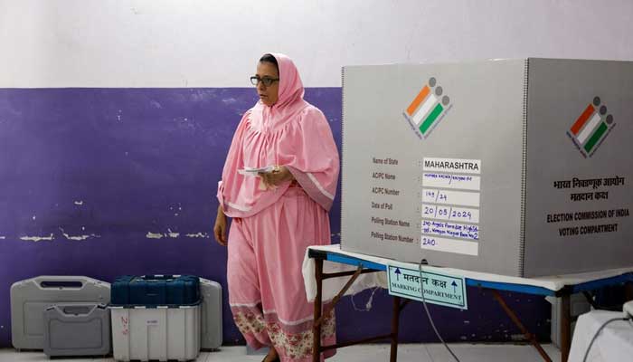 A woman leaves after casting her vote at a polling booth during the fifth phase of Indias general election, in Mumbra, on the outskirts of Mumbai, India, May 20, 2024. — Reuters