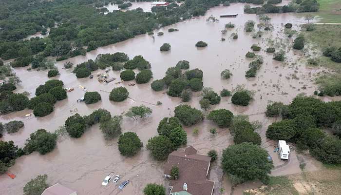 Houses and cars are partially submerged in flood waters in an aerial view near Kerrville, Texas, July 4. — Reuters
