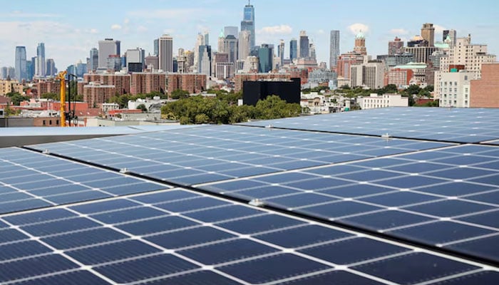 Solar panels are seen along with a view of the neighborhood and lower Manhattan from the rooftop of Timber House, the citys first mass-timber condo building, in the Park Slope neighborhood of Brooklyn, New York, U.S., August 16, 2022. — Reuters