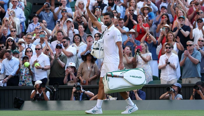 Serbias Novak Djokovic walks off the court after losing his semi final match against Italys Jannik Sinne. — Reuters