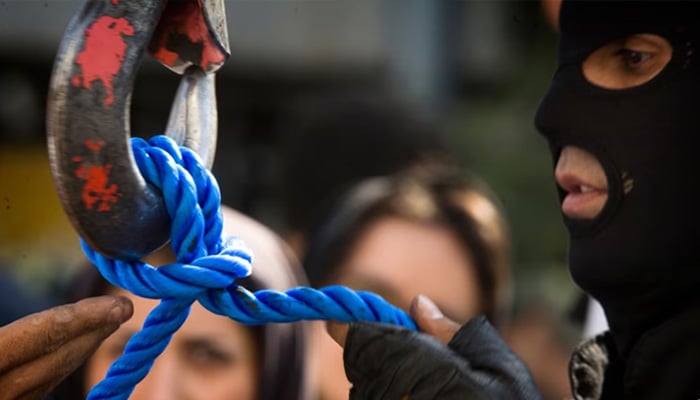 A member of Irans special police forces checks the rope before an execution by hanging, in Tehran. — Reuters