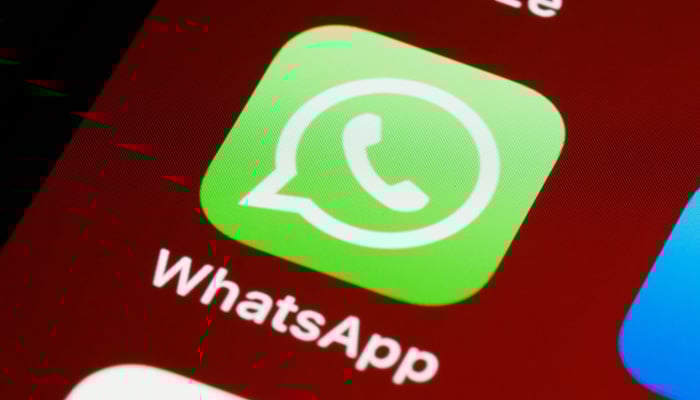 This representational image shows the WhatsApp icon displayed on a phone screen. — Unsplash