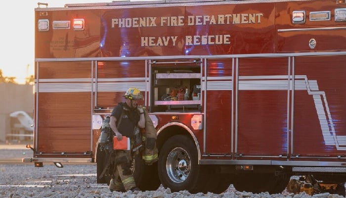A firefighter works as emergency crews respond after a midsize business jet skidded off the runway while landing and collided with another jet that was parked at the municipal airport in Scottsdale, Arizona, US, February 10, 2025. —Reuters