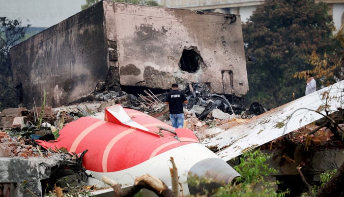 A firefighter stands next to the crashed Air India Boeing 787-8 Dreamliner aircraft, in Ahmedabad, India, June 13, 2025.