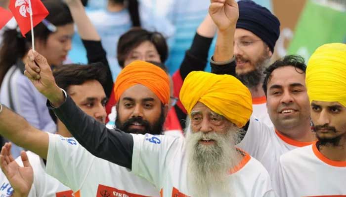 Fauja Singh (front), seen here after finishing a 10km race in Hong Kong in 2013. — AFP