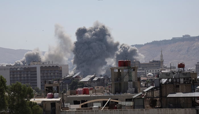 This representational image shows smoke rising after strikes on Syrias defence ministry in Damascus, Syria on July 16, 2025. — Reuters