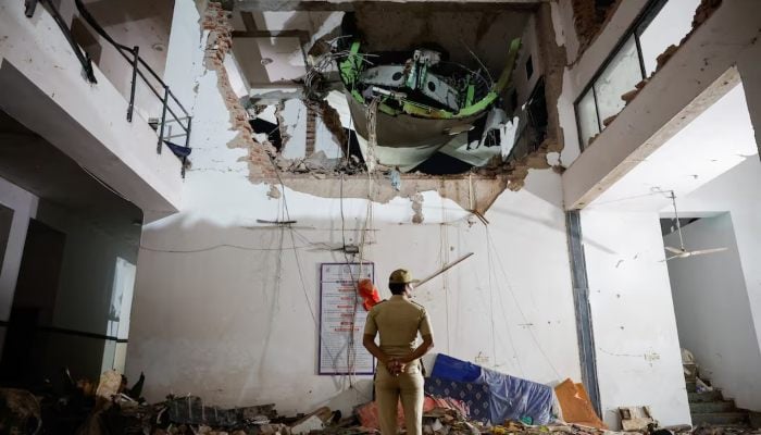 A police officer stands in front of the wreckage of an Air India aircraft, bound for Londons Gatwick Airport, which crashed during take-off from an airport in Ahmedabad, India June 12, 2025. — Reuters