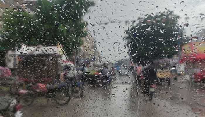 The image shows raindrops on a car window in Karachi. — Reuters/File