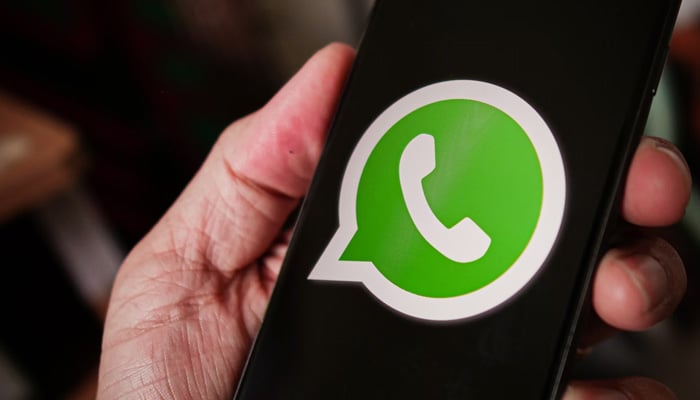 This representational image shows the WhatsApp logo displayed on a phone screen. — Unsplash