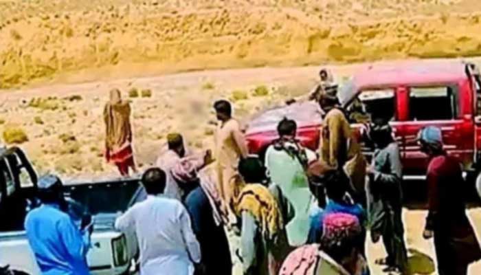Screengrab of viral video shows tribal members carrying out “honour killing” at unknown location in Balochistan. — X