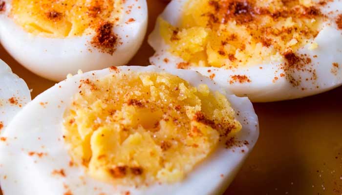 The image shows boiled eggs on a plate. — Unsplash/File