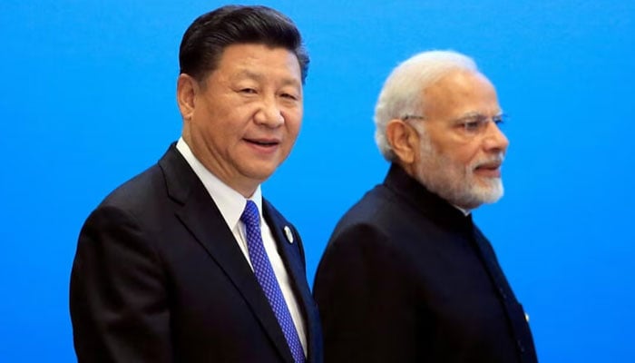 Chinas President Xi Jinping and Indias Prime Minister Narendra Modi arrive for a signing ceremony during the SCO summit in Qingdao, Shandong, China. — Reuters/File