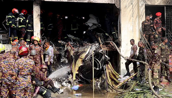 Firefighters and army members work next to the wreckage of an air force training aircraft after it crashed into Milestone College campus, in Dhaka, Bangladesh, July 21, 2025. — Reuters