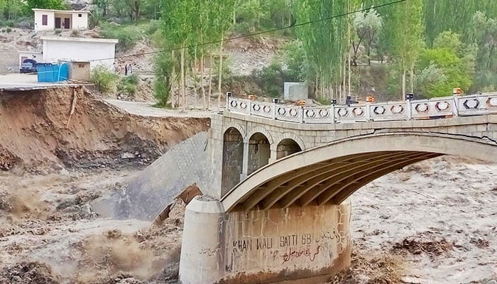 A part of the Hassanabad bridge in Gilgit-Baltistan is being washed away in the flood on May 7, 2022. —X/@SajidullahBaig