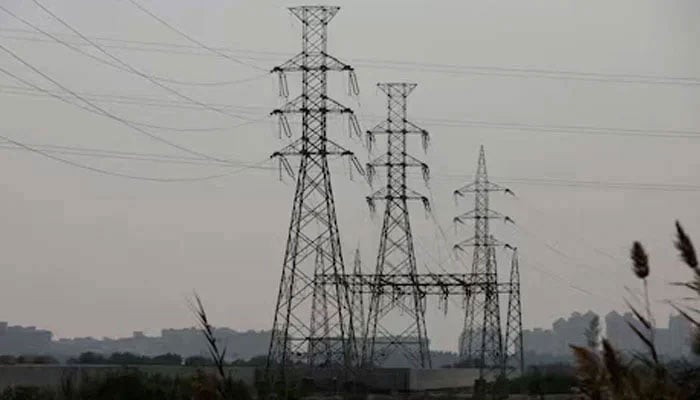 Power transmission towers are seen in Karachi on January 24, 2023. — Reuters
