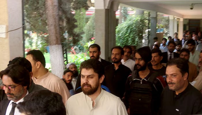 Policemen escort tribal chief Sher Baz Satakzai, accused of ordering the deaths of a couple in a so-called honour killing, at a local court in Quetta, July 21, 2025. — Reuters