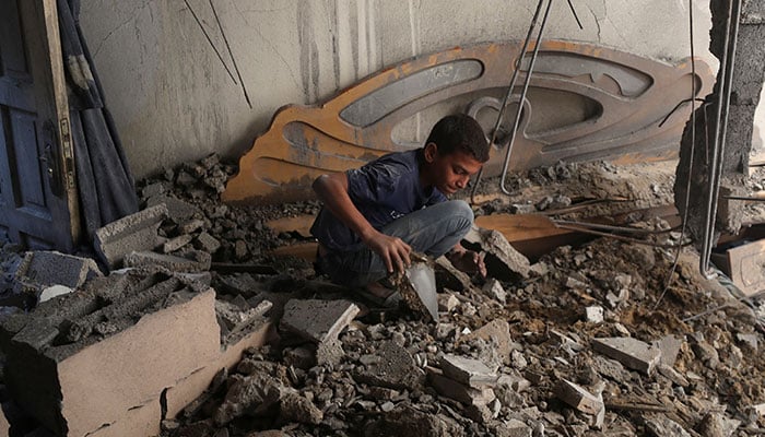 A Palestinian boy inspects the site of an overnight Israeli air strike on a house in Gaza City on July 23, 2025. — Reuters