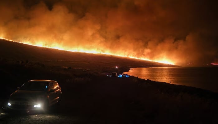 A wildfire burns near Alacati in Izmir province, Turkey, July 3. —Reuters