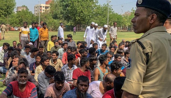Detained Bangladeshi migrants are pictured at a crime branch office following an overnight operation by the state police in Ahmedabad on April 26, 2025. — AFP