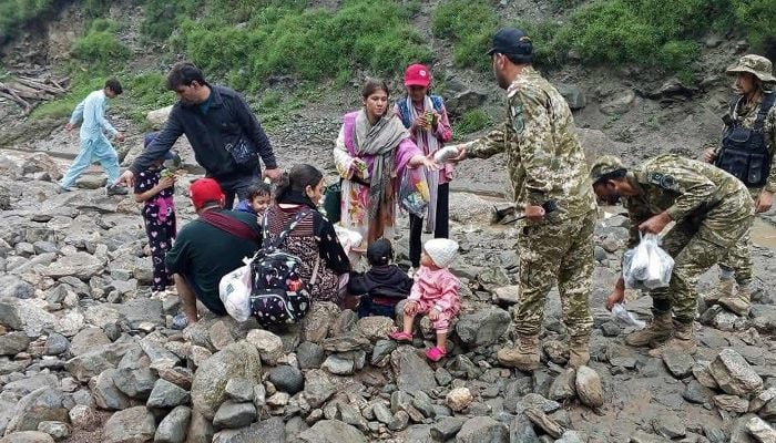 This handout photograph released on July 22, 2025 by the Government of Gilgit-Baltistan shows army soldiers helping visitors to evacuate the landslide hit area in Babusar, Gilgit-Baltistan region. — AFP