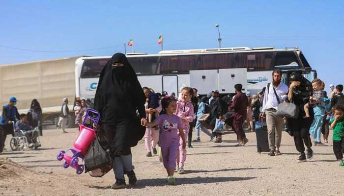 An Iranian bus drops off Afghan refugees at Zero Point on the Islam Qala border in Herat Province on July 24, 2025. — AFP