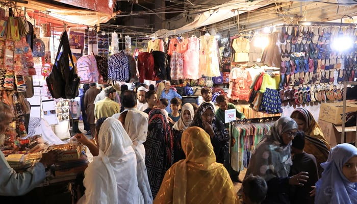 People shop in the market in Karachi, March 29, 2025. — Reuters