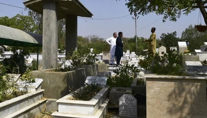 Representational image shows people in a cemetery. — AFP/File