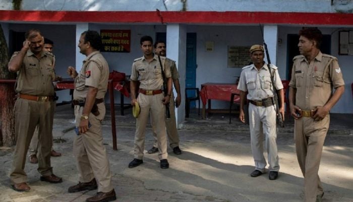 Indian policemen standing inside a police station in Uttar Pradesh, India. — Reuters