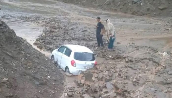 A car is stuck in mud following a landslide due to heavy rains in Gilgit Baltistan. — Geo News