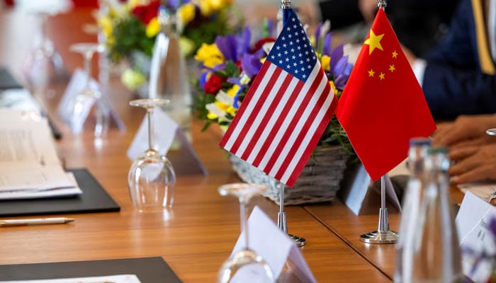 The American and Chinese flags are photographed on the negotiating table, during a bilateral meeting between the United States and China, in Geneva, Switzerland, May 10, 2025. — Reuters