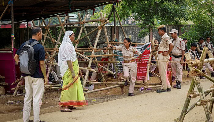 Security officials are guards at a control point near a demolition site in the Goalpara district in the northeast state of Assam, India, July 18, 2025. - Reuters