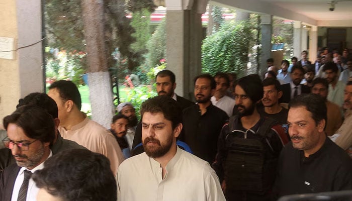 Policemen escort tribal chief Sher Baz Satakzai, accused of ordering the deaths of a couple in a so-called honour killing, at a local court in Quetta on July 21, 2025. — Reuters