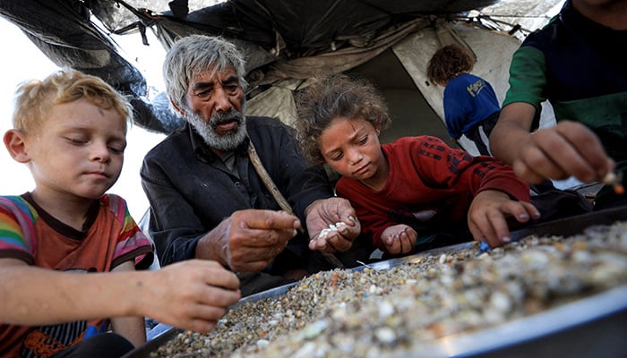Displaced Palestinians who have not received humanitarian aid gather as they survive on leftover food, amid a hunger crisis, in Gaza, July 28, 2025. — Reuters