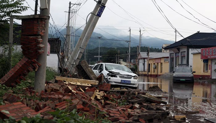 Debris lie next to a damaged car after a heavy rainfall flooded the area, in Miyun district of Beijing, China July 28, 2025. — Reuters