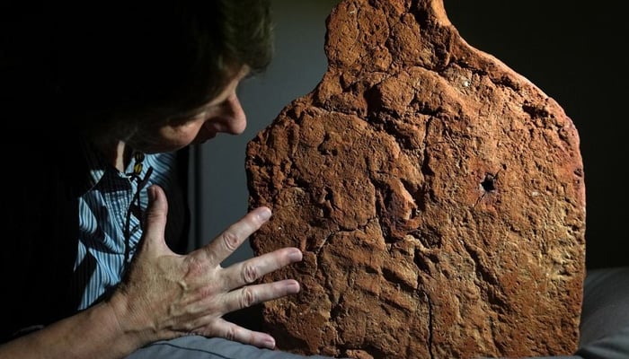 Helen Strudwick, curator of Made in Ancient Egypt, views a 4,000-year-old ancient Egyptian handprint discovered on a soul house at the Fitzwilliam Museum in Cambridge, Britain. — AFP/File