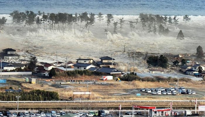 A massive tsunami sweeps in to engulf a residential area after a powerful earthquake in Natori, Miyagi Prefecture in northeastern Japan, March 11, 2011. —Reuters