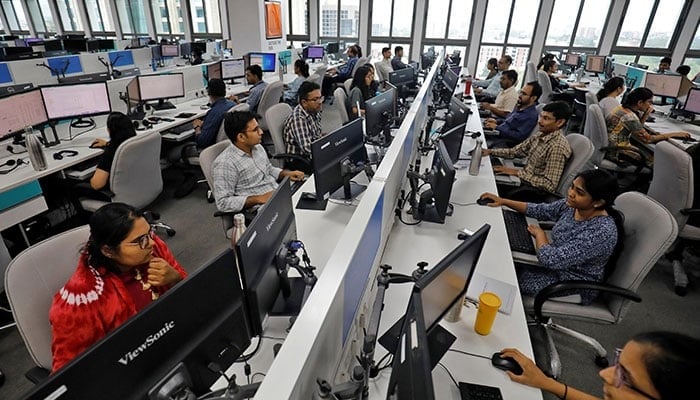Representational image shows employees working on their terminals inside an office. — Reuters/File